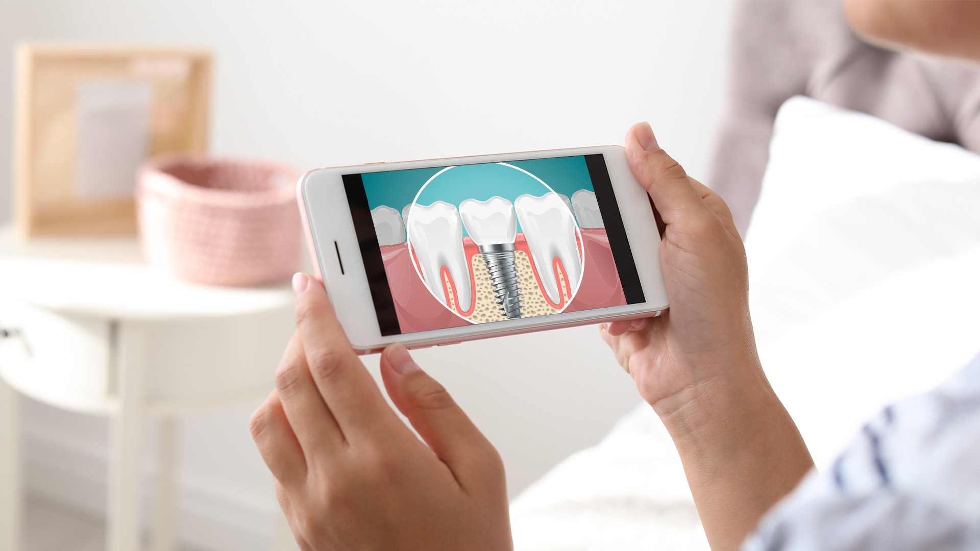 A person holding a smartphone displaying an image of a tooth with a cavity, likely for dental education or promotion purposes.