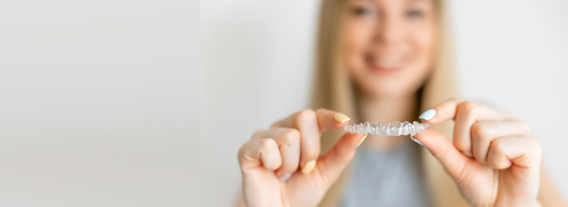 The image shows a person holding up a small object with their hand, displaying it against a plain background.