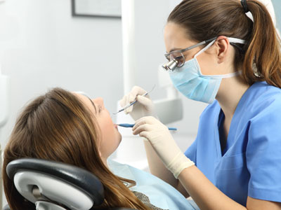 Dentist performing dental procedure on patient.